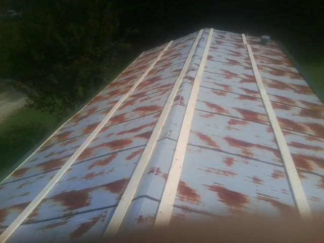 Rusted metal roof panels with new wood purlins before replacement — Storm Damage Roof Repair in Cranberry by Roofing Brothers